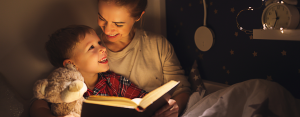 a mother and son cuddling together reading a book